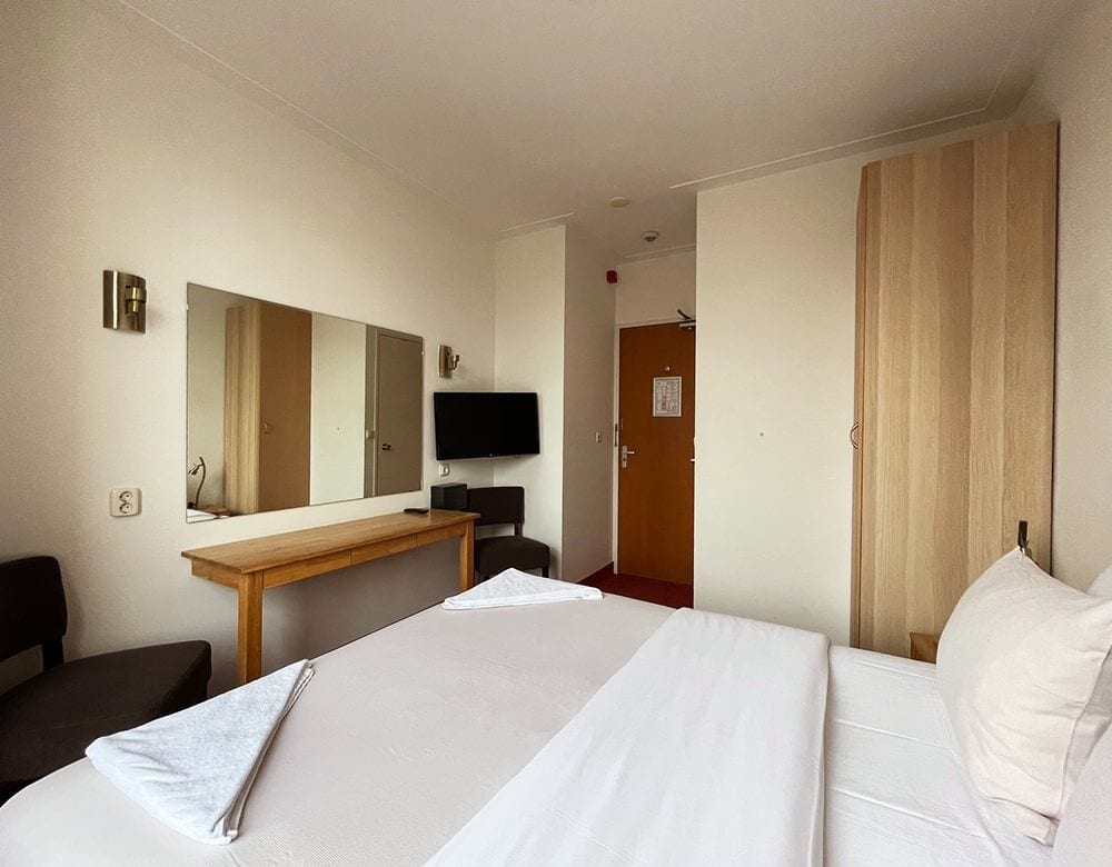 Small Double Room: a desk with a mirror and television opposite the bed