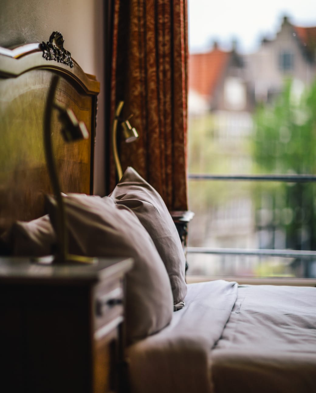 Guest bedroom at the Wiechmann Hotel, with a canal view through the open window